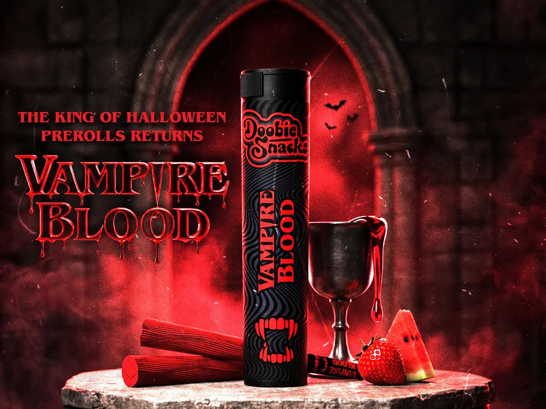 Doobie Snacks Vampire Blood, the returning Halloween seasonal. A black pre-roll tube with red fangs and dripping lettering beside a pewter goblet pouring blood-red, with a strawberry and a watermelon wedge, in a red-lit gothic archway.